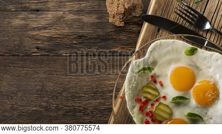 Banner Fried Eggs Sunny Side Up On A Rustic Table With Copy Space.
