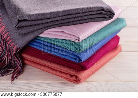 A Neatly Stacked Stack Of Cashmere Shawls, Scarves In Multi-colored Colors. Women's Accessory, Gift 