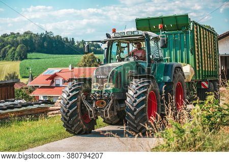 Bavaria/ Germany - August 07,2020: Fendt Favorit 926 Vario Tractor Drives With A Krone Zx400gl Trail