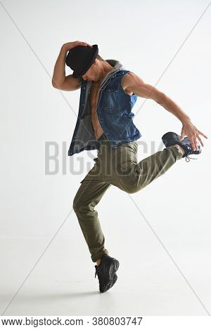 Cool Young Guy Breakdancer In Hat Dancing Hip-hop In Studio Isolated On White Background. Break Danc