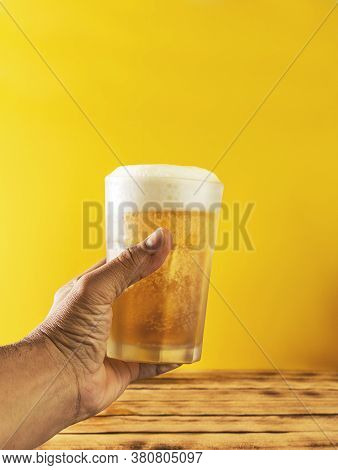 Hand With Beer Tosting Cheers, Selective Focus.