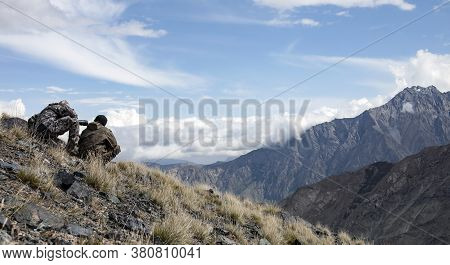 Hunting Ibex In The Mountains Determine Trophy Quality Animals Through Binoculars And A Telescope.  
