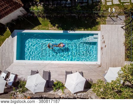 Two Person Swim In The Pool At The Hotel. View From Above, Couple Men And Women In Swimming Pool Of 