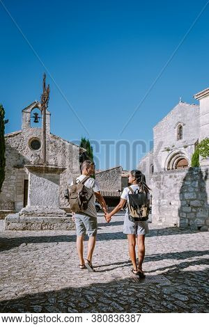 Couple Visit The Town Of Les Baux De Provence France, Old Historical Village Build On A Hill In The 