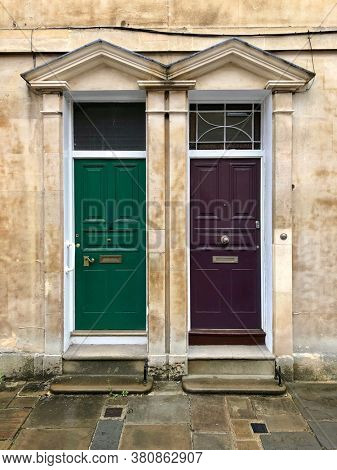 Two front doors of adjoining terraced townhouses