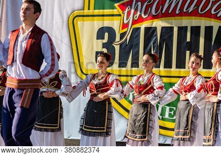 Young Men And Girls Dancing Serbian Traditional National Folk Dance Kolo