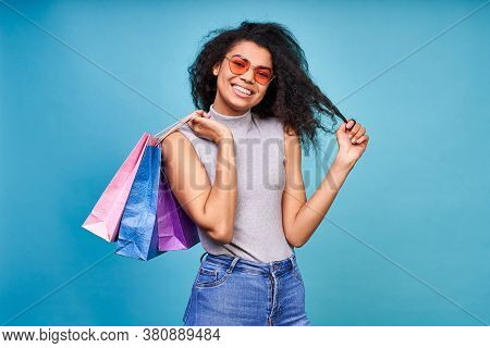Attractive Young Dark Skinned Woman With Sincere Happy Smile Holding A Bunch Of Shopping Bags Isolta