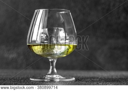 Glass Of Chartreuse On The Rocks On Black Backround