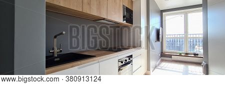 Close-up Of Luxury Studio Apartment In City Centre. Light Compact Flat. Modern Wooden Kitchen With S