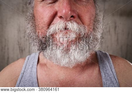 Old man with unkempt untrimmed beard