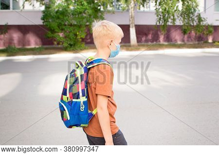 Back To School. School-age Boy With A Protective Medical Mask On Her On His Face With A School Backp