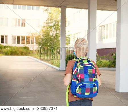 Back To School. School-age Boy With A Protective Medical Mask On Her On His Face With A School Backp