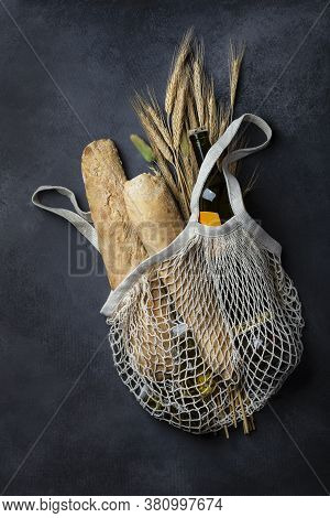 Homemade Italian Bread Baguette Stirato And A Bottle Of Wine In A Shopping Bag
