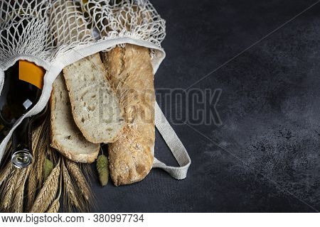 Homemade Italian Bread Baguette Stirato And A Bottle Of Wine In A Shopping Bag