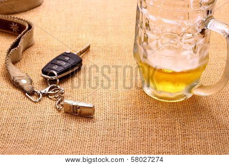 Car Key With A Tilted Toy Car And Beer Mug