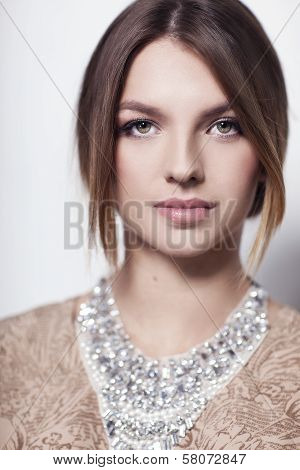 Beautiful high fashion model with necklace isolated on white background