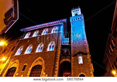 Night view of downtown with enlightened Town Hall in Piombino, Italy