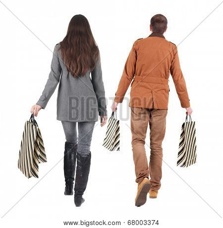 walking couple with shopping bag. rear view. Isolated over white.