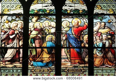 PARIS,FRANCE - NOV 11,2012:Jesus gives Peter the keys to the Kingdom, stained glass.The Church of St Severin is Catholic church in the Latin Quarter. It is one of the oldest churches on the Left Bank.
