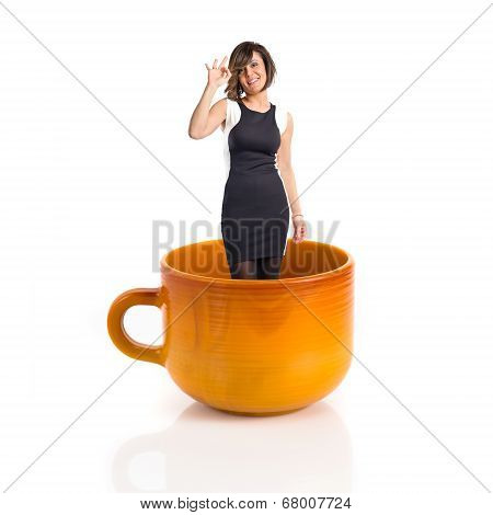 Woman Inside Ceramic Cup Over White Backgrpund