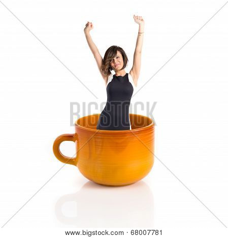 Woman Inside Ceramic Cup Over White Backgrpund