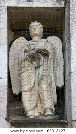 PARMA, ITALY - MAY 01, 2014: Angel, marble statue on the baptistry from Benedetto Antelami. Baptistery in Parma is considered to be among the most important Medieval monuments in Europe.