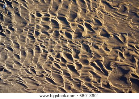 Wet sand on Baltic beach in Ustka, Poland. Natural textured background.