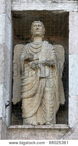 PARMA, ITALY - MAY 01, 2014: Angel, marble statue on the baptistry from Benedetto Antelami. Baptistery in Parma is considered to be among the most important Medieval monuments in Europe.