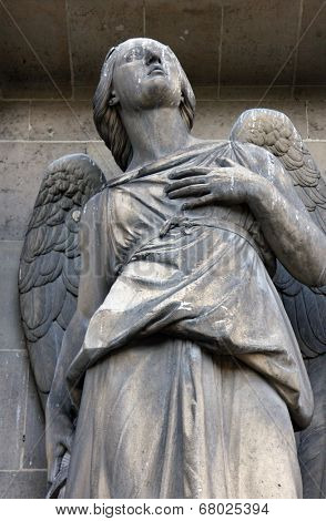PARIS, FRANCE - NOV 09, 2012: Archangel Michael, architectural details of Eglise de la Madeleine. Madeleine Church was designed in its present form as a temple to the glory of Napoleon's army.