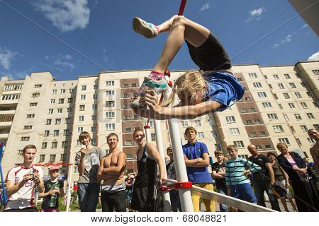 TIKHVIN, RUSSIA - JULY 7, 2014: Unidentified participants city competitions in Street workout timed to the celebration of the day of the city of Tikhvin.