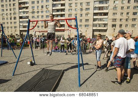 TIKHVIN, RUSSIA - JULY 7, 2014: Unidentified participants city competitions in Street workout timed to the celebration of the day of the city of Tikhvin.