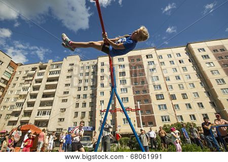 TIKHVIN, RUSSIA - JULY 7, 2014: Unidentified participants city competitions in Street workout timed to the celebration of the day of the city of Tikhvin.