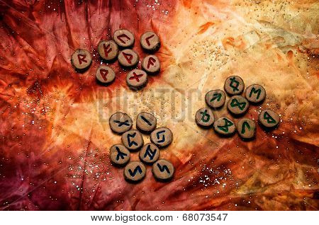Set Of Runes Divided Into Aetts On Mottled Colorful Fabric