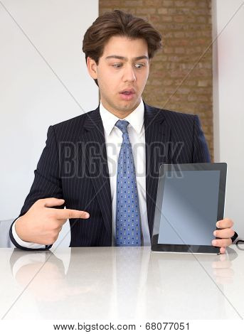 Businessman Pointing To A Tablet In Horror