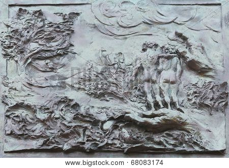 PORT AZZURRO,ELBA,ITALY - MAY 03,2014:God Creating the Earth,Adam and Eve,detail on the door of the church of St. James the Greater. Church is located inside the fort of the same name in Porto Azzurro
