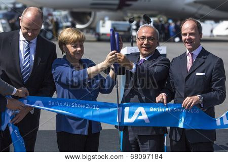 BERLIN, GERMANY - MAY 20, 2014: German Chancellor Angela Merkel, Turkish Minister of transport Lutfi Elvan and CEO Mr Christian (C.-R.) open up the International aviation and space exhibition ILA.
