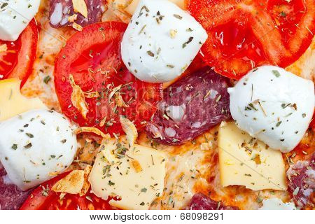 Raw pizza dough with mozzarella and proscuitto on top