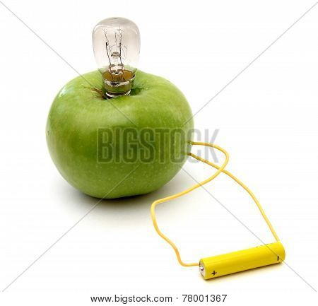 Green Apple With A Lamp Connected To A Battery