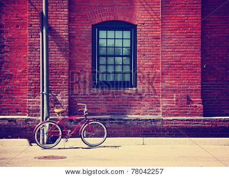 a bike in front of a brick wall during summer toned with a retro vintage instagram filter effect