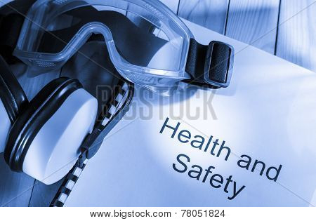 Register With Goggles And Earphones On Wooden Background