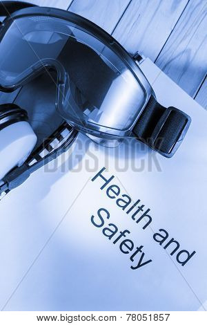 Register With Goggles And Earphones On Wooden Background