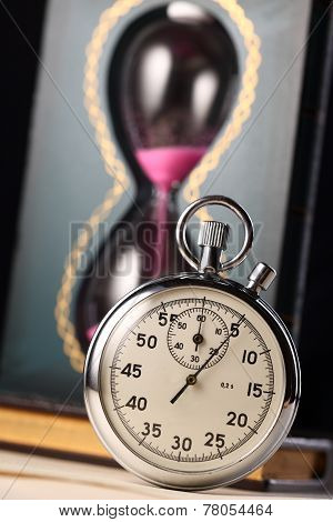 Stopwatch And Sand Watch On Black Background