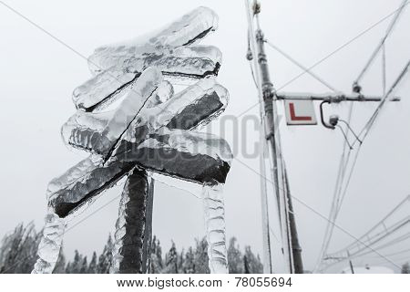 Frozen Cross And Electrical Lines For Railroad With Icicles