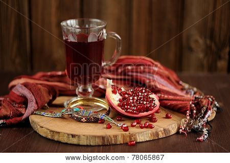 Peeled Pomegranate, Glass Of Pomegranate Juice And Jewerly On Wooden Board