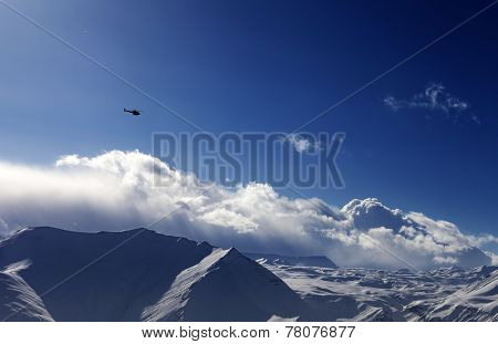 Helicopter Above Snowy Plateau In Evening