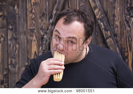 man eating a hot dog
