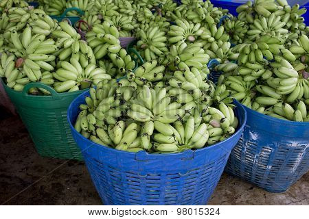 Many Green Bananas In Basket Ready To Sell In Market