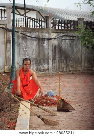 buddist monk is resting after the street cleaning