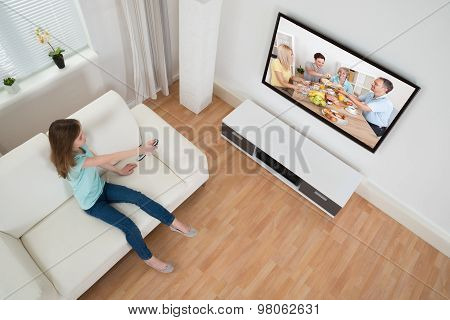 Girl Holding Remote Control In Front Of Television