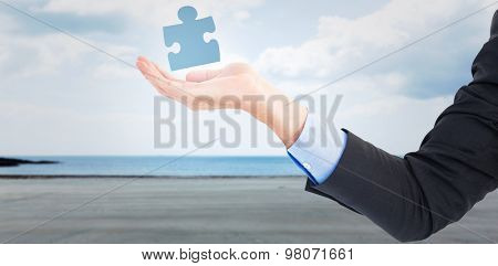 Close up of businessman with empty hand open against beach